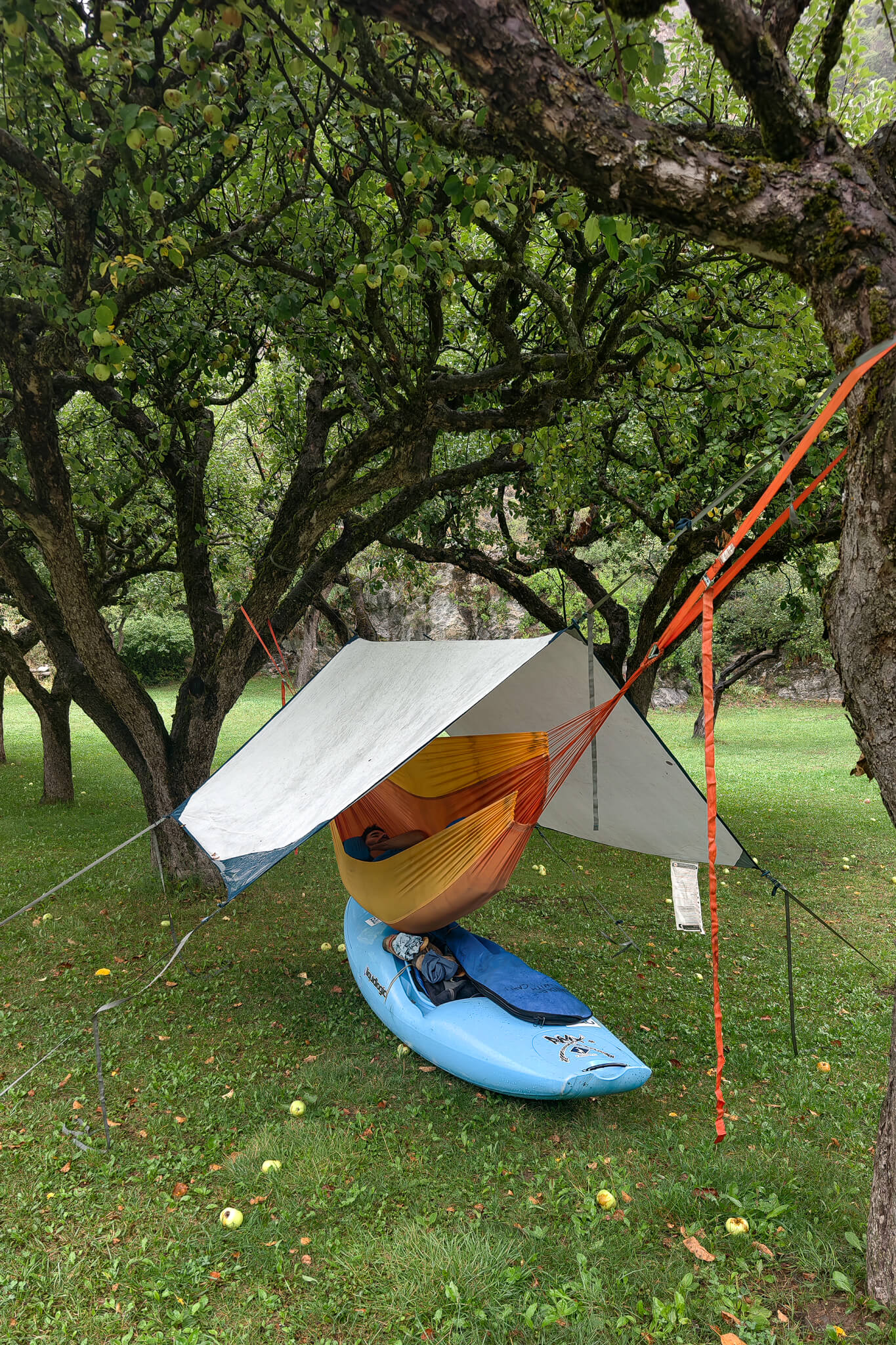 ubayak-07-camp-hammock-tarp-by-cedric-eyma Camp under the apple trees: tarp, hammock with Éric Deguil inside, and the kayak parked underneath.